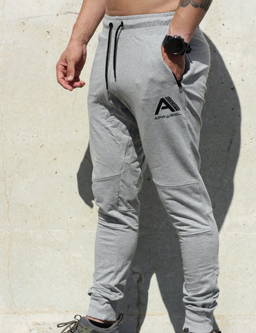 Grey track pants, with pockets.