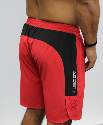 Red men's gym shorts, 7" length, with zip pockets.